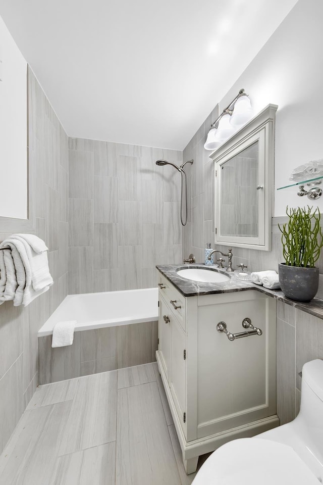 555 Main St Unit 602, New York City, NY 10044 - bathroom featuring tile walls, vanity, and tiled shower / bath