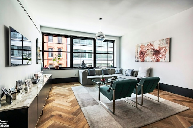 living area featuring baseboards