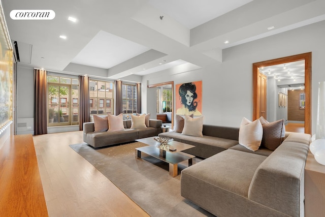 living area featuring visible vents and wood finished floors