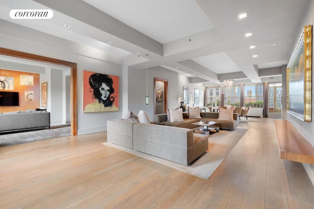 living area with light wood-type flooring, baseboards, visible vents, and beamed ceiling