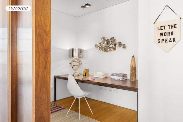 office area with hardwood / wood-style flooring and built in desk