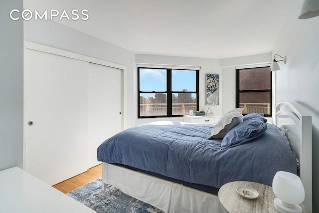 bedroom with a closet and wood finished floors