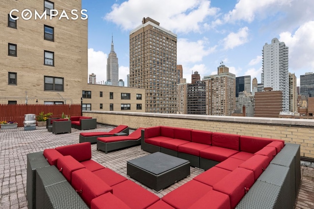 view of patio with outdoor lounge area and a city view