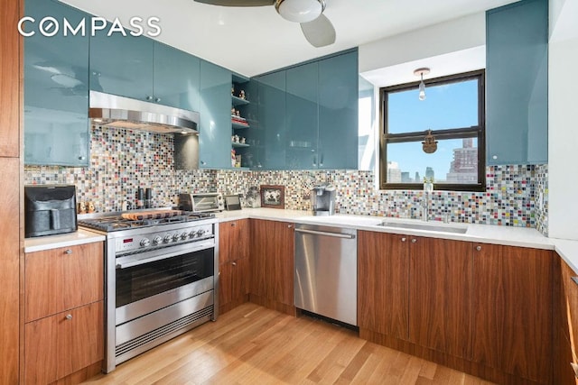 kitchen featuring stainless steel appliances, brown cabinets, a sink, and ventilation hood