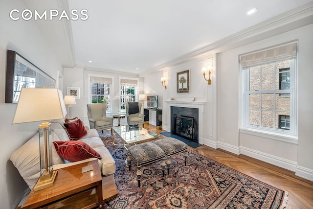 living room with baseboards, recessed lighting, a fireplace with flush hearth, and crown molding