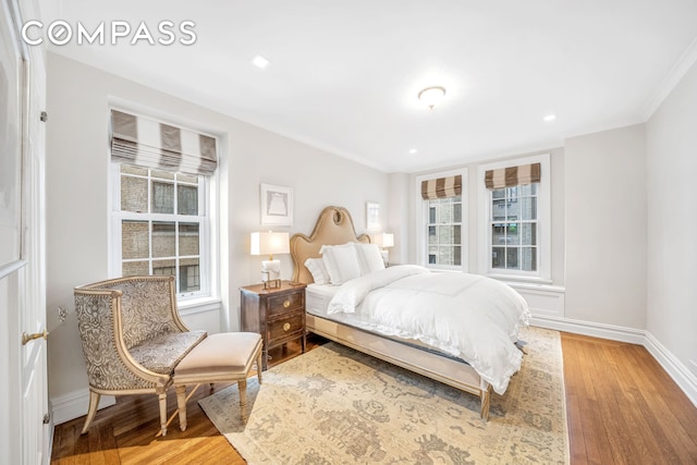 bedroom with recessed lighting, baseboards, multiple windows, and light wood-style flooring