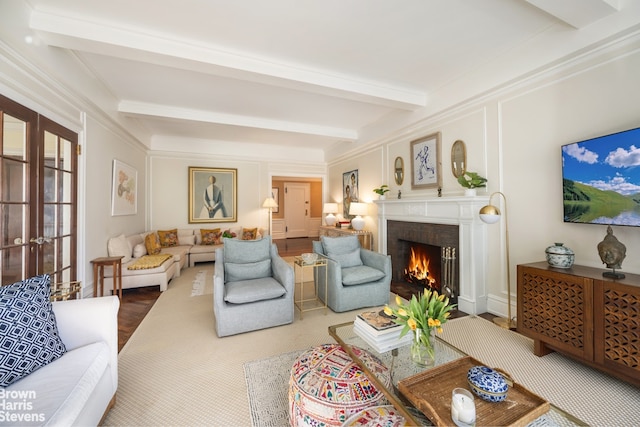 living room featuring a fireplace, ornamental molding, and beam ceiling