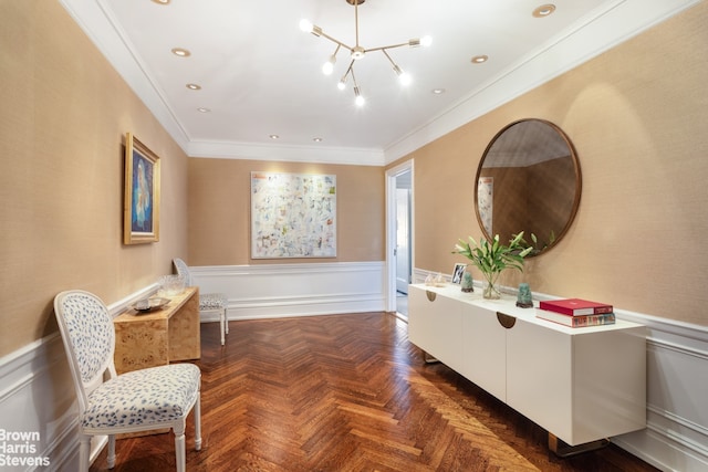 living area featuring recessed lighting, a decorative wall, crown molding, wainscoting, and an inviting chandelier