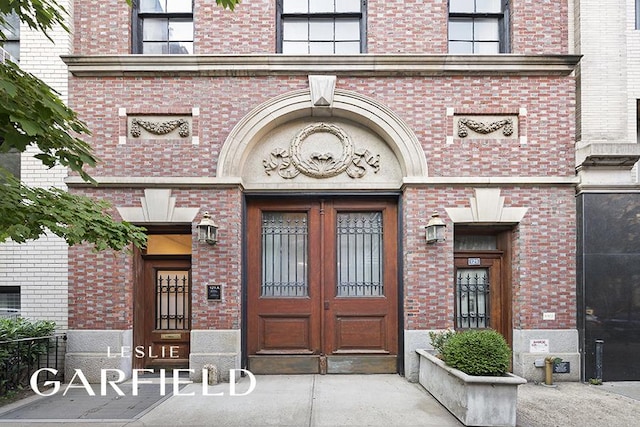 entrance to property featuring brick siding