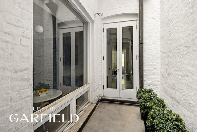 doorway to property with french doors and brick siding