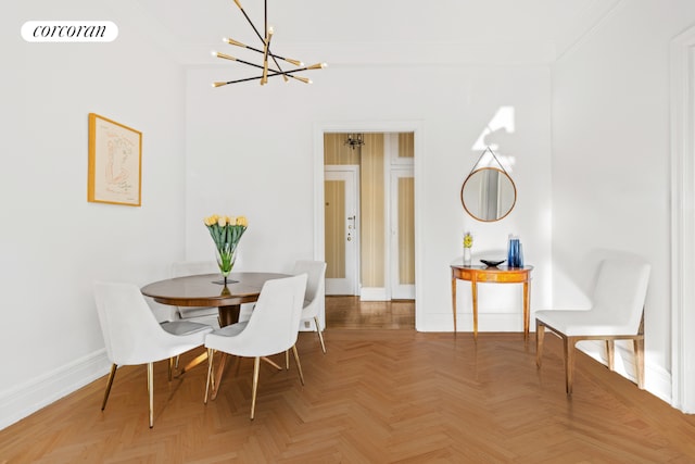 dining area with ornamental molding, an inviting chandelier, and parquet floors