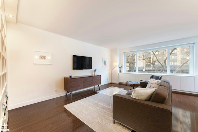 living room with dark wood-style flooring and baseboards