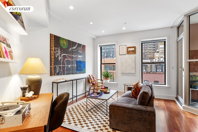 living room with a wealth of natural light, wood finished floors, and recessed lighting