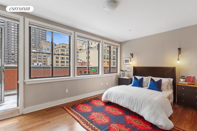 bedroom with wood finished floors and baseboards