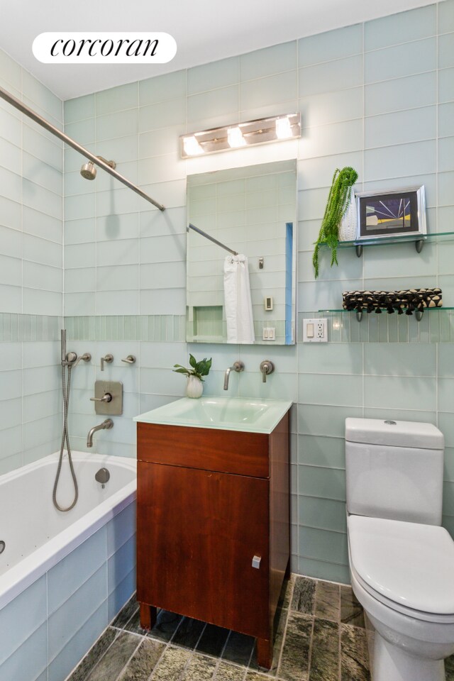 345 E 50th St Unit 5A, New York City, NY 10022 - full bath with tiled shower / bath, tile walls, and vanity