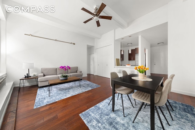 dining room featuring hardwood / wood-style floors, beamed ceiling, a ceiling fan, and baseboards