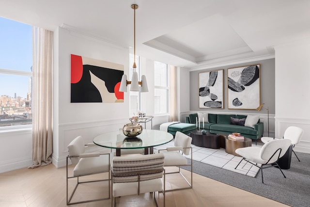 108 Leonard St Unit 7H, New York City, NY 10013 - dining area with healthy amount of natural light, a raised ceiling, light wood-style floors, ornamental molding, and baseboards