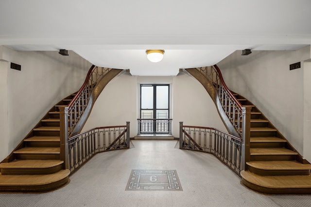 additional living space featuring carpet floors and stairway
