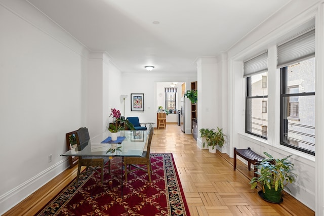 home office with plenty of natural light, crown molding, and baseboards