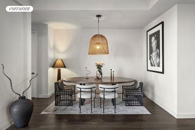 dining room with wood finished floors, baseboards, and visible vents