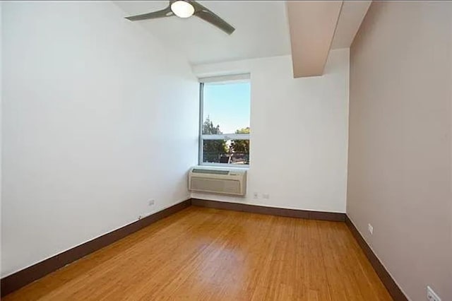 5-43 48th Ave Unit 3A, New York City, NY 11101 - spare room with a wall mounted air conditioner, wood finished floors, and ceiling fan