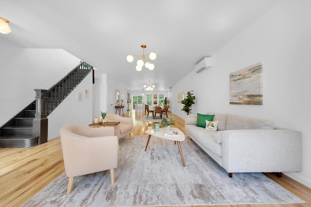 living room featuring a wall unit AC, a chandelier, and wood-type flooring