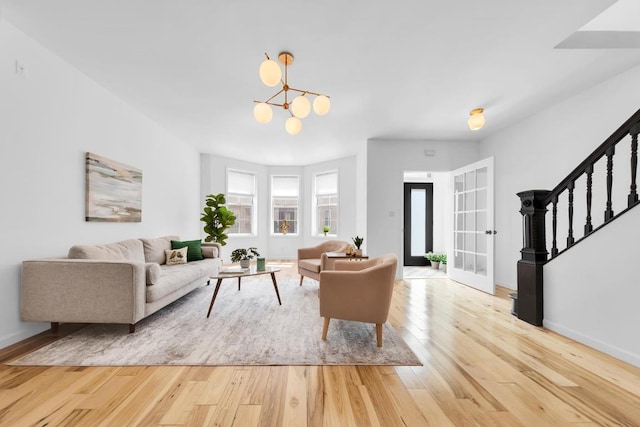 living room with light hardwood / wood-style flooring and french doors