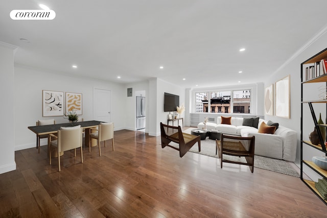 living area featuring recessed lighting, visible vents, wood finished floors, and ornamental molding