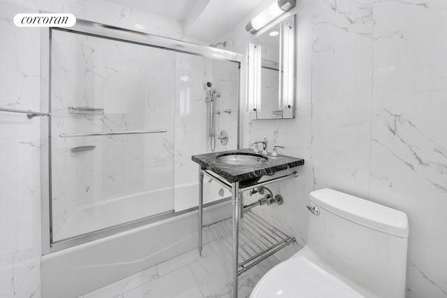 bathroom featuring a sink, marble finish floor, and toilet