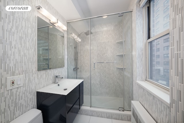 bathroom featuring plenty of natural light, a stall shower, tile patterned floors, and vanity