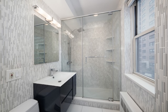 bathroom with a stall shower, tile patterned flooring, vanity, and toilet