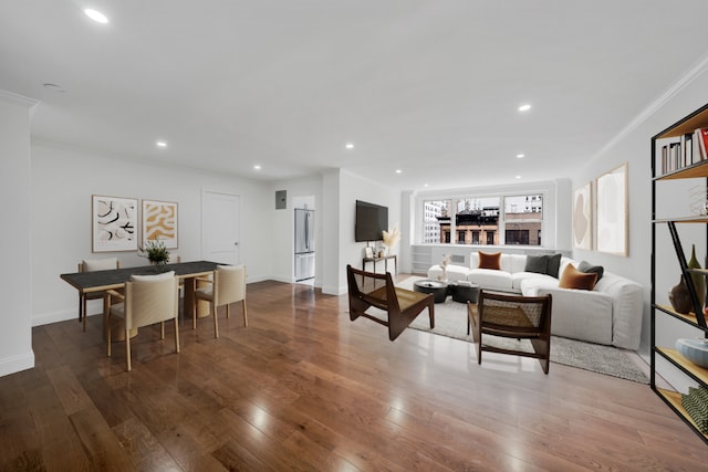 living room with crown molding and dark wood-type flooring