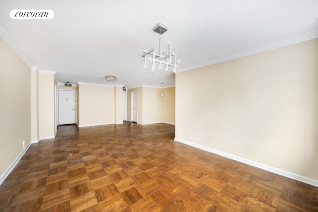 empty room featuring baseboards, a notable chandelier, visible vents, and crown molding