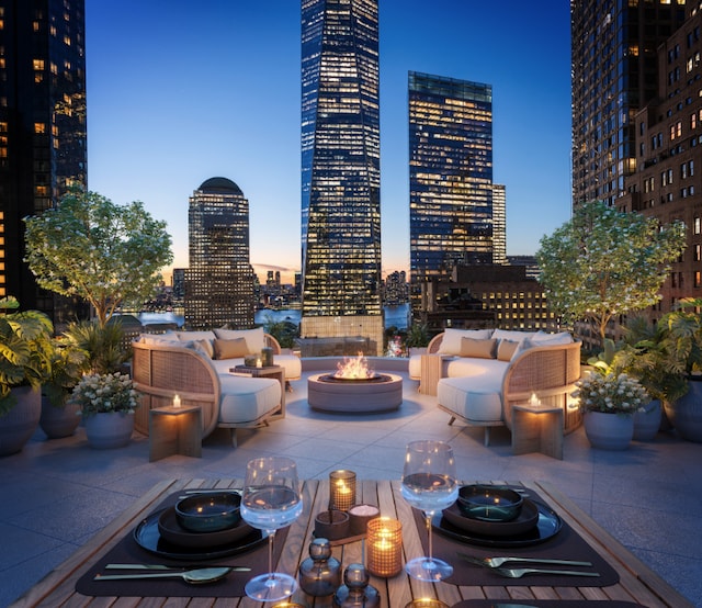 patio terrace at dusk featuring an outdoor living space with a fire pit