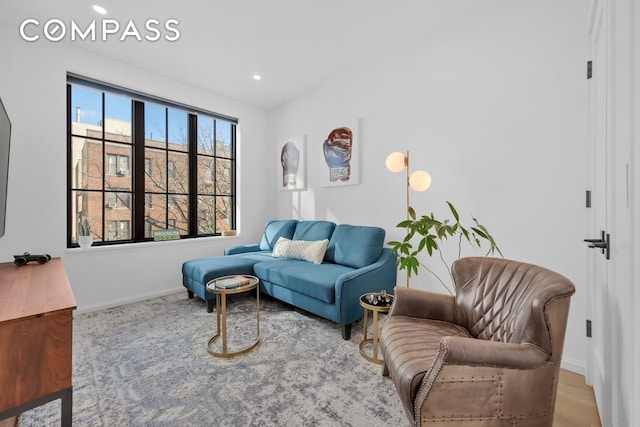 living area featuring recessed lighting and baseboards