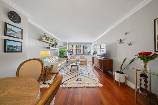 living area featuring dark wood-type flooring, crown molding, and baseboards