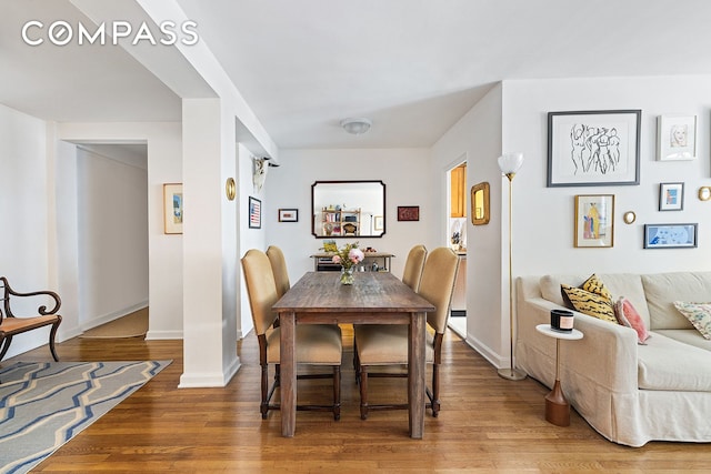 dining area featuring wood finished floors and baseboards