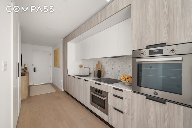 kitchen featuring light countertops, oven, and modern cabinets