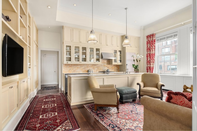 living room featuring a decorative wall, recessed lighting, dark wood-style flooring, and ornamental molding