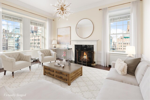 1 Sutton Pl S Unit 12D, New York City, NY 10022 - living area featuring a chandelier, healthy amount of natural light, wood finished floors, a warm lit fireplace, and ornamental molding