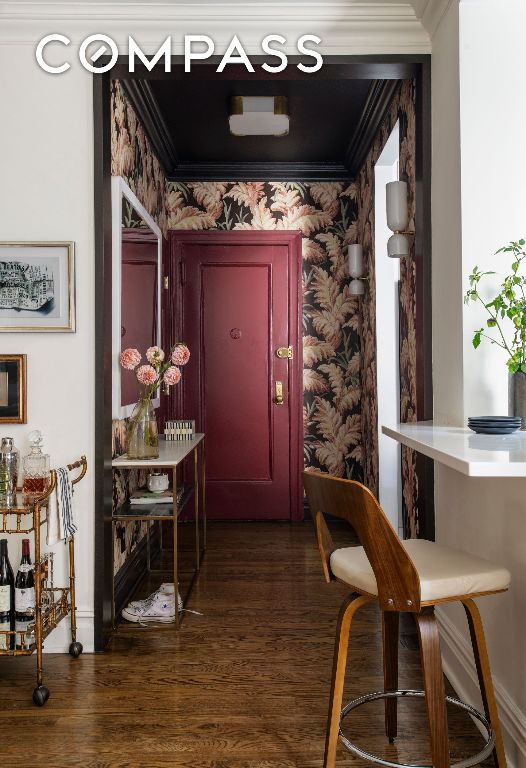 hallway featuring ornamental molding and dark wood-type flooring