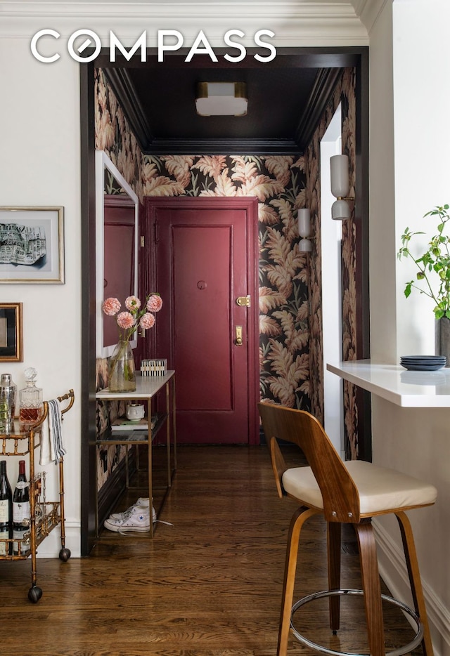 hallway featuring ornamental molding, dark wood-style flooring, and wallpapered walls