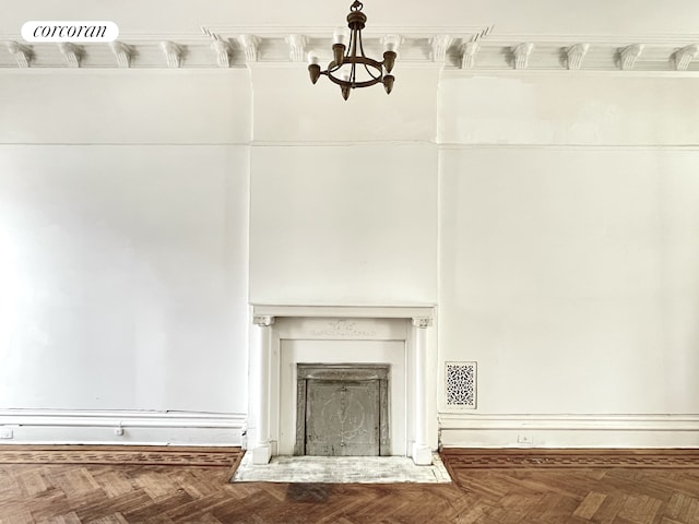 room details featuring a fireplace, visible vents, and a notable chandelier