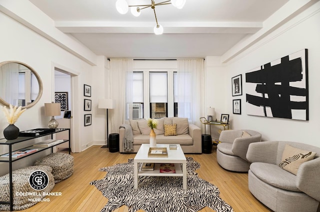 living area with beam ceiling, light wood-type flooring, and baseboards