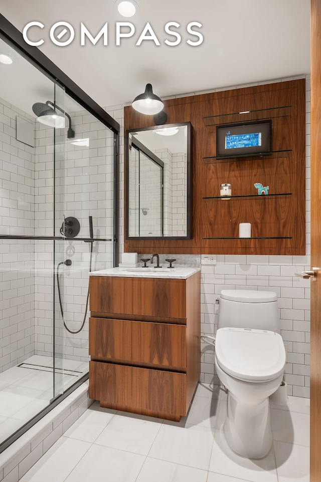 bathroom featuring tile patterned flooring, a shower stall, toilet, and vanity