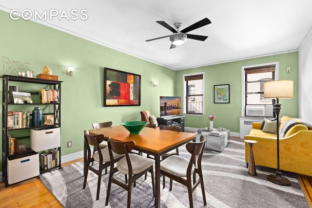 dining space with radiator heating unit, baseboards, ceiling fan, and crown molding