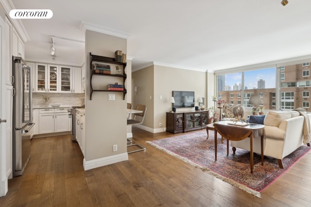 living area featuring dark wood-type flooring, visible vents, crown molding, and baseboards