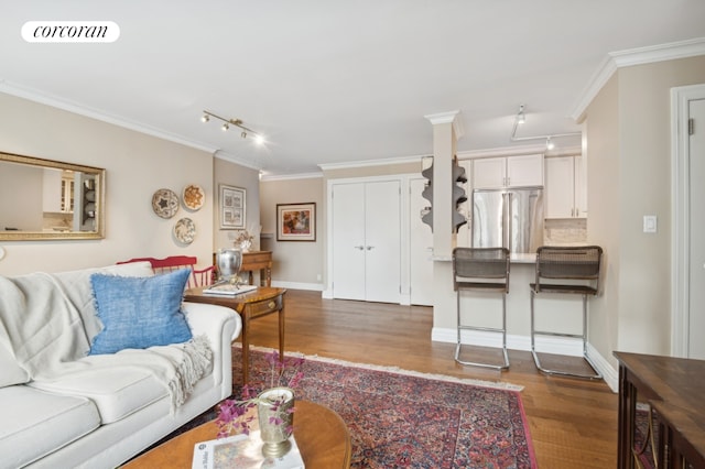 living room with dark wood-style floors, visible vents, and crown molding