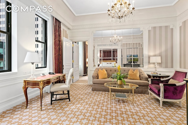 carpeted living area with a chandelier, crown molding, and a decorative wall