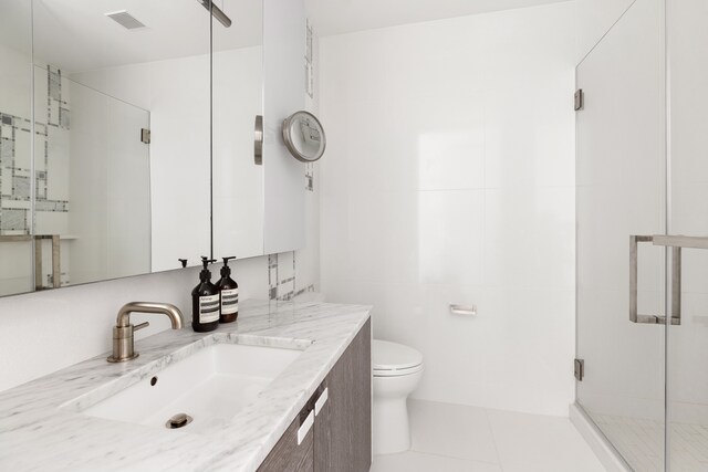 138 Willoughby St Unit 15F, New York City, NY 11201 - full bathroom featuring a shower stall, tile patterned flooring, toilet, and vanity